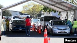 Members of the public wait in cars to be inoculated against COVID-19 during a one-day "Vaxathon," in Auckland, New Zealand, Oct. 16, 2021. 