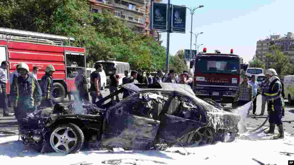 This photo released by the Syrian official news agency SANA, shows burning cars after a car bomb exploded in Mazzeh, Damascus, April 29, 2013.