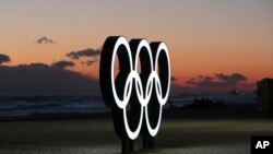 FILE - Olympic rings are placed on the beach before sunrise in Gangneung, South Korea, Jan. 24, 2018. Gangneung is the site of the coastal cluster which will host ice hockey, figure skating, speedskating, short track and curling for the 2018 Olympics from Feb. 9 to 25.