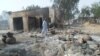 A man walks past burnt out houses following an attack by Boko Haram in Dalori village 5 kilometers (3 miles) from Maiduguri, Nigeria, Jan. 31, 2016.