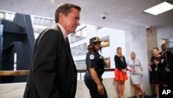 National intelligence inspector general Michael Atkinson, left, leaves a closed intelligence briefing, Thursday Sept. 26, 2019, on Capitol Hill in Washington. 