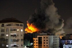 Smoke rises from a tower after it was hit by Israeli airstrikes amid a flare-up of Israeli-Palestinian violence, in Gaza City, May 12, 2021.