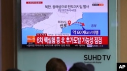 Visitors sit in front of the TV screen showing a news program reporting about North Korea's missile firing, at Seoul Train Station in Seoul, South Korea, April 5, 2017.