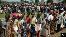 Internally displaced people wait for rations at a World Food Program distribution point near a makeshift camp set up in Bangui, Central African Republic, Dec. 13, 2013.