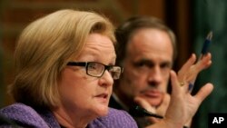 FILE - Homeland Security and Governmental Affairs Committee member Sen. Claire McCaskill, D-Mo., asks a question during a hearing on Capitol Hill in Washington, Dec. 4, 2007. Sen. Tom Carper, D-Del. is at right. 