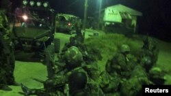 An undated handout photograph released by Kenya's Ministry of Defense on September 29, 2012, shows members of the Kenyan Defense Forces during an operation at an undisclosed location in Somalia. 
