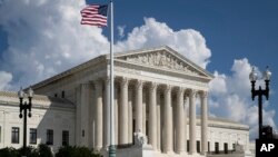 An American flag flies outside the Supreme Court in Washington, Sept. 3, 2018.