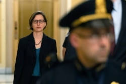 Deputy Assistant Secretary of Defense Laura Cooper arrives for a closed door meeting to testify as part of the House impeachment inquiry into President Donald Trump, Oct. 23, 2019, on Capitol Hill in Washington.
