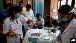A patient has his blood taken to be tested at a fever clinic especially set up to cater to those suffering from fever, one of the main symptoms of several mosquito-borne diseases such as dengue, at a hospital in New Delhi, India, Sept. 15, 2016. The World