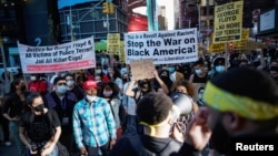 People gather with signs after the verdict in the trial of former Minneapolis police officer Derek Chauvin, found guilty of the death of George Floyd, in New York City, New York, U.S., April 20, 2021. (REUTERS/Eduardo Munoz)