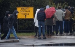 People queue at a testing center amid the outbreak of the coronavirus disease, in Southport, Britain, Feb. 2, 2021.