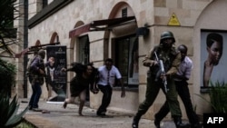FILE - Kenyan security forces help people to escape after a bomb blast at DusitD2 hotel in Nairobi, Kenya, Jan. 15, 2019. 