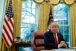 FILE - President Donald Trump talks with reporters in the Oval Office of the White House, Sept. 4, 2019.