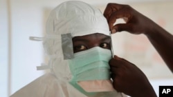 FILE - A nurse gears up to enter a high-risk zone of an Ebola treatment unit run by Doctors Without Borders / Medecins Sans Frontieres in Monrovia, Liberia.