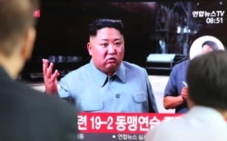 People watch a TV showing a file image of North Korean leader Kim Jong Un during a news program at the Seoul Railway Station in Seoul, South Korea, July 25, 2019. North Korea fired two unidentified missiles Thursday, South Korea's military said.