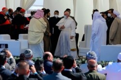 Pope Francis, center, prepares to leave after an inter-religious meeting near the archaeological site of Ur, near Nasiriyah, Iraq, March 6, 2021.