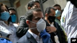FILE - Venezuelan opposition leader Juan Guaido arrives at the headquarters of the Democratic Action political party, in Caracas, Venezuela, June 17, 2020.
