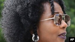 In this June 28, 2018 photo, artist Sheila Pree Bright, 51, speaks during a press conference announcing "Off the Walls." The project will create up to 30 murals to be installed around Atlanta before the 2019 Super Bowl.