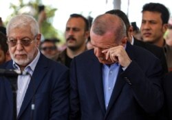 FILE - Turkish President Recep Tayyip Erdogan reacts as he attends funeral prayers in absentia for ousted former Egyptian President Mohammed Morsi, at Fatih Mosque in Istanbul, June 18, 2019.