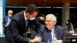 Italy's Foreign Minister Luigi Di Maio, left, talks to European Union foreign policy chief Josep Borrell during a European Foreign Affairs Ministers meeting at the European Council building in Luxembourg, June 21, 2021.