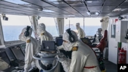 FILE - In this photo provided by the British Ministry of Defence, members of the HMS Diamond's Bridge team shoot down a missile fired by the Iranian-backed Houthis from Yemen, April 24, 2024. 