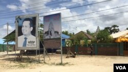 A portrait of the late Kem Ley is seen on a road in his hometown in Tram Kak district in Leay Bor commune, Takeo province, Cambodia, July 9, 2018. (Hul Reaksmey/VOA Khmer) 