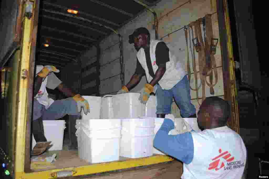 Workers for Doctors Without Borders distribute home disinfectant kits to prevent Ebola in Monrovia, Liberia, Oct. 20, 2014. 
