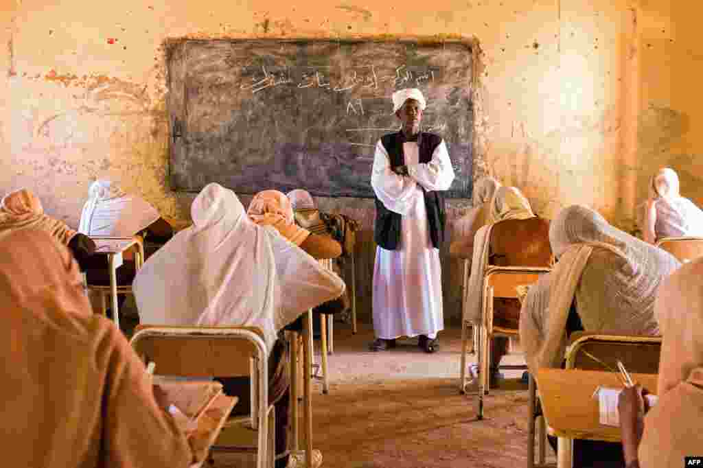 A teacher watches over middle school students during their end-of-year exams in the northern Sudanese village of Usli.