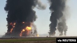 Fire and smoke rise from an explosion of gas tankers in Herat, Afghanistan, Feb. 13, 2021, in this picture obtained by Reuters from a video. 