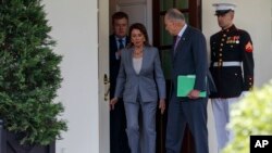FILE - Speaker of the House Nancy Pelosi of Calif., and Senate Minority Leader Sen. Chuck Schumer of N.Y., walk out of the White House after meeting with President Donald Trump about infrastructure, April 30, 2019, in Washington. 