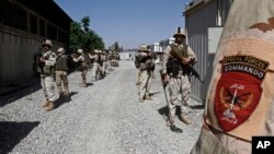 FILE - Afghan special forces demonstrate their skills at a training center in Kandahar, south of Kabul, Afghanistan, May 4, 2014. Afghanistan is shifting its focus from conventional warfare to special operations in an effort to help defeat a growing insurgency as well as an emerging threat from the Islamic State group.