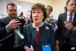 FILE - Sen. Susan Collins, R-Maine, is surrounded by reporters as she heads to vote at the Capitol in Washington, Nov. 6, 2019.