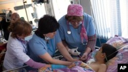 Doctors render aid to 12-year-old Gevorg Grigoryan, who was wounded in a missile barrage by Azerbaijani forces, in a hospital in Stepanakert, in the separatist Nagorno-Karabakh region, Armenia, April 2, 2016.
