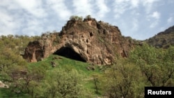 A view of the entrance to Shanidar Cave in the foothills of the Baradost Mountains in Iraq’s northern Kurdistan region, the site where fossils of 10 Neanderthals have been unearthed is seen in an undated photo. (Courtesy of Graeme Barker/Handout via REUTERS)