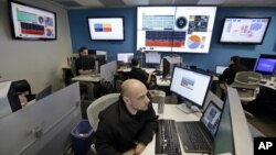 FILE - Microsoft control technician Ray Nichols monitors energy usage in real time at Microsoft Corp.'s operations center in Redmond, Wash.