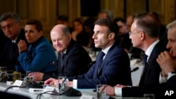 French President Emmanuel Macron, center, delivers a speech at the Elysee Palace in Paris, Feb. 26, 2024. More than 20 European heads of state and government and other Western officials are gathering in a show of unity for Ukraine. 