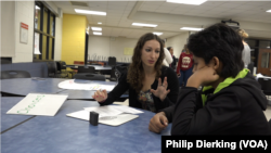 Higher Achievement mentor Michelle Davis works works with one of the program's students