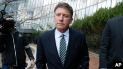 Bruce Isackson departs federal court in Boston, April 3, 2019, after facing charges in a nationwide college admissions bribery scandal.