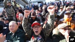 A South Korean Vietnam War veteran shouts during a rally to denounce the United States' demand for raising the defense costs for stationing U.S. troops in South Korea, near the U.S. embassy in Seoul, South Korea, Nov. 20, 2019.