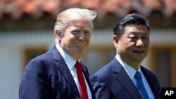 President Donald Trump and Chinese President Xi Jinping walk together after their meetings at Mar-a-Lago, April 7, 2017.