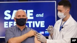 Vice President Mike Pence receives a Pfizer-BioNTech COVID-19 vaccine shot at the Eisenhower Executive Office Building on the White House complex, Friday, Dec. 18, 2020, in Washington. Karen Pence, and U.S. Surgeon General Jerome Adams also participated. 