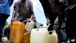 People sell black market fuel on the street in Lagos, Nigeria, May 30, 2023.