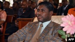 FILE - Teodorin Obiang Nguema, the son of Equatorial Guinea's president Teodoro Obiang Nguema sits during a mass at Malabo's Cathedral to celebrate his 41st birthday, June 25, 2013.