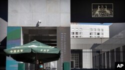 A Chinese paramilitary policeman stands guard at the Australian Embassy in Beijing, Sept. 1, 2020.