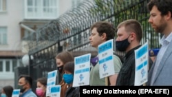 Protesters hold banners with the names of missing Crimean activists during a protest in front of the Russian Embassy in Kyiv, May 26, 2021.