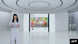 This handout image obtained June 7, 2021 courtesy of Apple Inc. shows Apple's director of App Store Product Marketing Ann Thai highlights new ways for developers to showcase what's happening in their apps.