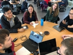 Jacqueline Deprey (center, in maroon cardigan), a computer science student, works on a project with classmates in a game design and development class, Jan. 28, 2020, at the University of Maryland in College Park, Md. (Julie Taboh/VOA)