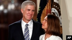 Judge Neil Gorsuch stands with wife Louise as President Donald Trump announces him as his choice for the Supreme Court at the East Room of the White House in Washington, Jan. 31, 2017. 