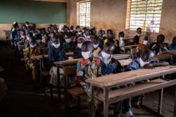 Children sit in their classroom on the first day of the new school year, in Ouagadougou, Burkina Faso, on Oct.1, 2020.