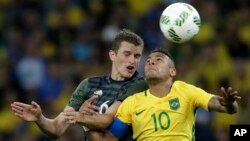 FILE - Germany's Sven Bender, left, and Brazil's Neymar go for a header during the final match of the men's Olympic football tournament won by Brazil in Rio de Janeiro, Aug. 20, 2016. 